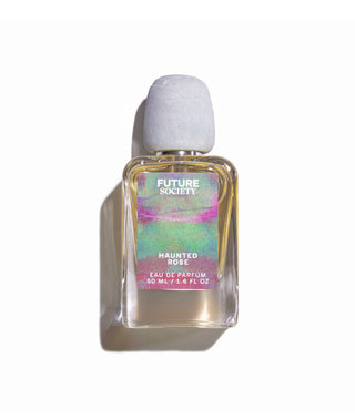 Perfume bottle labeled "Haunted Rose" on white background