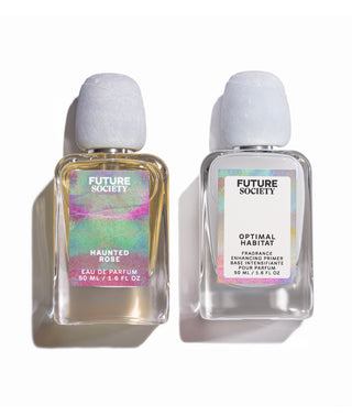 Two Future Society fragrance bottles on a white background: Haunted Rose Eau de Parfum with a multicolor iridescent label and Optimal Habitat Fragrance with a white label.