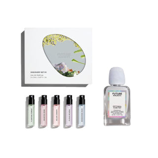 A fragrance discovery set by Future Beauty on a white background, featuring a white box with a floral oval illustration, five small sample spray vials in assorted pastel colors, and one clear bottle of Eau de Parfum with a white cap. Discovery Set 01 includes Wandering Rain, Cloud Reverie, Solar Canopy, Haunted Rose, Floating Forest.